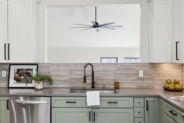 kitchen with a ceiling fan, a sink, dark countertops, tasteful backsplash, and dishwasher