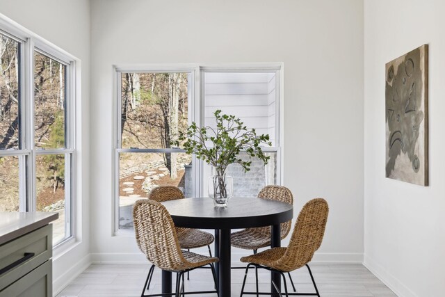 dining space with light wood-style floors and baseboards