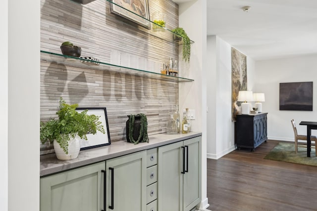 bar featuring baseboards and dark wood-style flooring