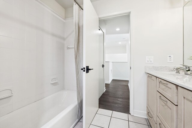 full bathroom featuring tile patterned flooring, shower / washtub combination, vanity, and baseboards