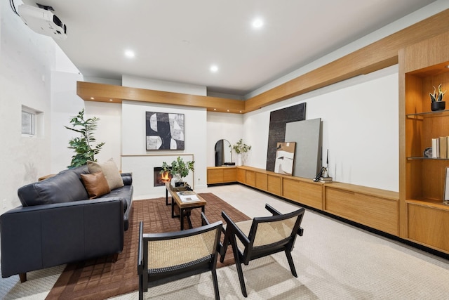 living area featuring recessed lighting and a lit fireplace