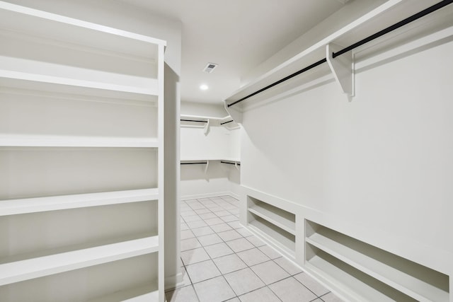 walk in closet with light tile patterned floors and visible vents