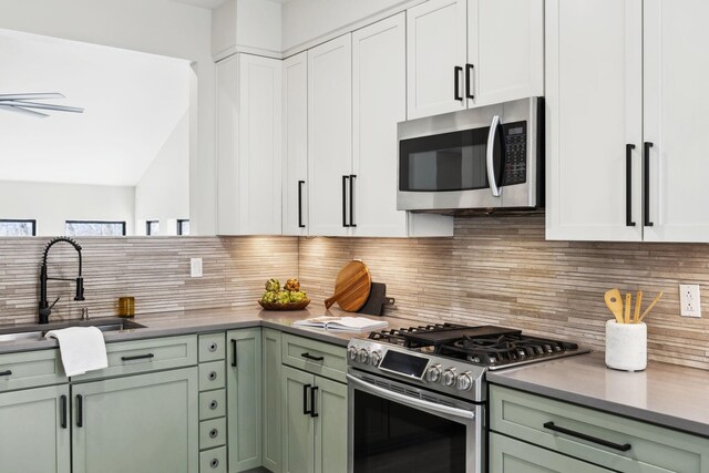 kitchen with a sink, tasteful backsplash, green cabinetry, and stainless steel appliances