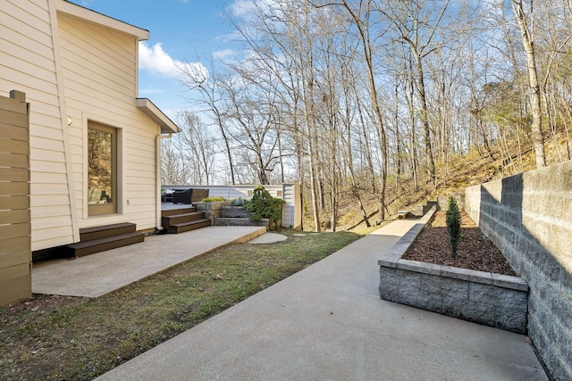 view of yard featuring a deck, a patio, and fence