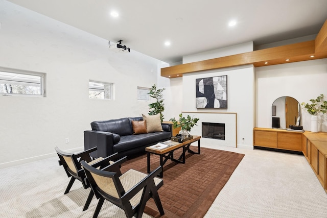 carpeted living area with recessed lighting, baseboards, arched walkways, and a fireplace