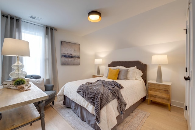 bedroom with visible vents, baseboards, and light wood-style floors