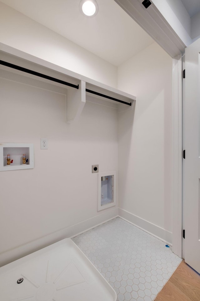 laundry room featuring washer hookup, laundry area, baseboards, and hookup for an electric dryer