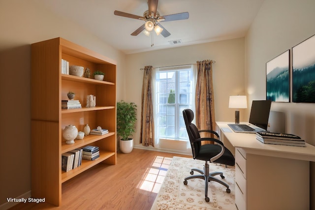 office area with visible vents, light wood finished floors, and ceiling fan