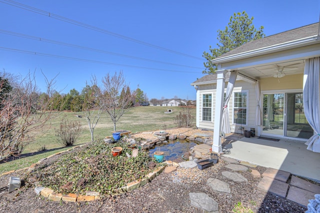 view of yard with a patio and ceiling fan