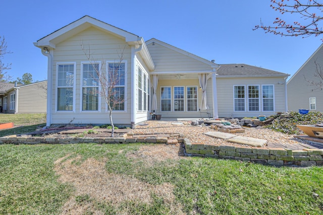 rear view of property with a yard