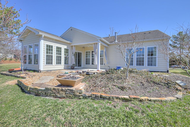 rear view of property featuring a yard and a patio