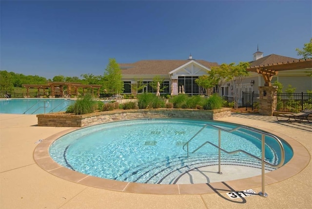 community pool featuring a pergola and fence