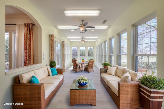 sunroom / solarium with a ceiling fan, visible vents, and a wealth of natural light