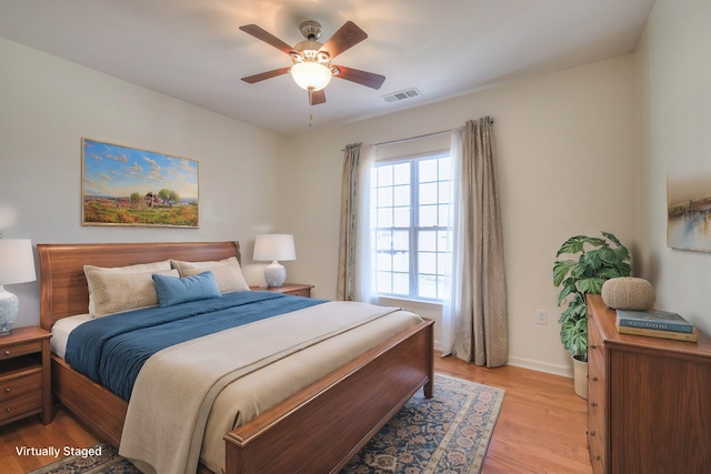 bedroom featuring visible vents, a ceiling fan, light wood-type flooring, and baseboards