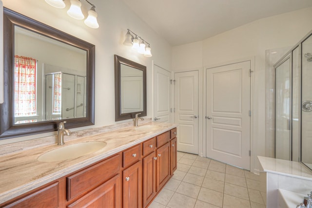 bathroom featuring tile patterned flooring, a stall shower, and a sink