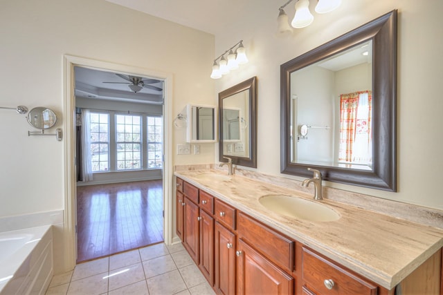 bathroom featuring tile patterned flooring, double vanity, ceiling fan, and a sink