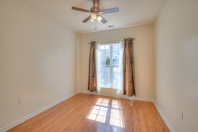 unfurnished room with visible vents, baseboards, a ceiling fan, and light wood finished floors