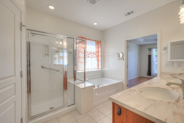 bathroom featuring tile patterned floors, visible vents, a bath, and a shower stall