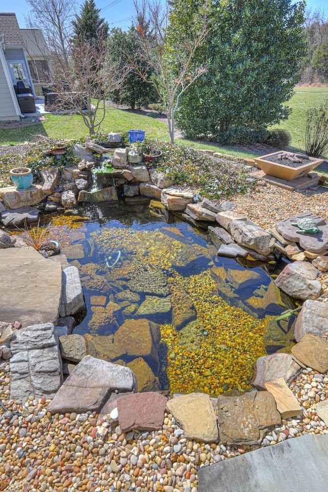 view of patio featuring a small pond