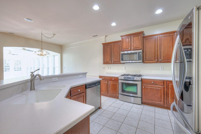 kitchen with light tile patterned floors, recessed lighting, a sink, light countertops, and appliances with stainless steel finishes