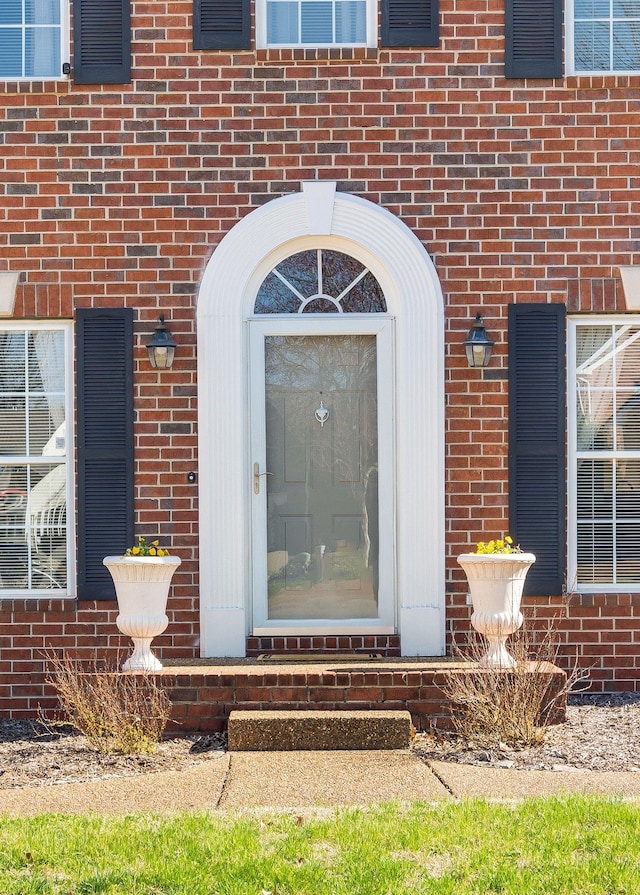 property entrance with brick siding