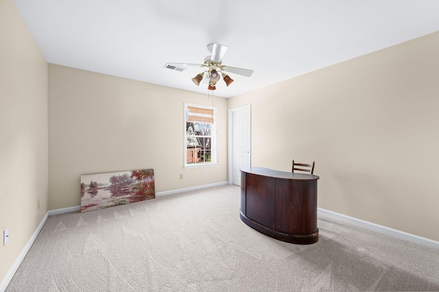 home office with visible vents, a ceiling fan, carpet, and baseboards