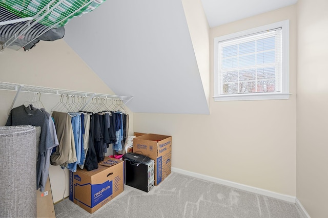 walk in closet with lofted ceiling and carpet flooring