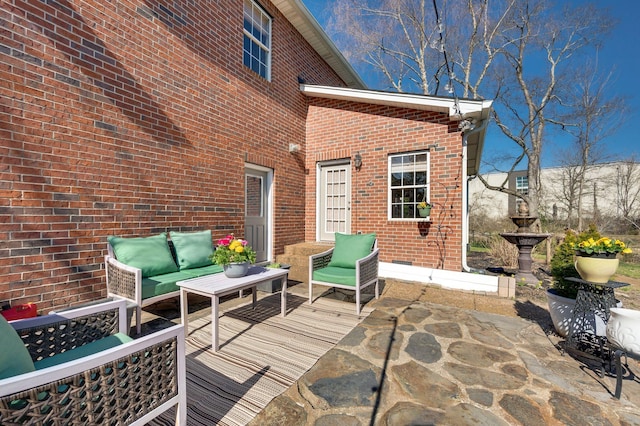 wooden terrace featuring a patio and an outdoor hangout area