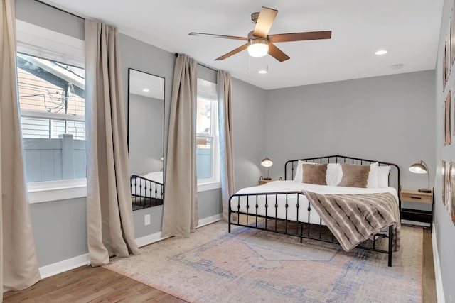 bedroom featuring recessed lighting, a ceiling fan, baseboards, and wood finished floors