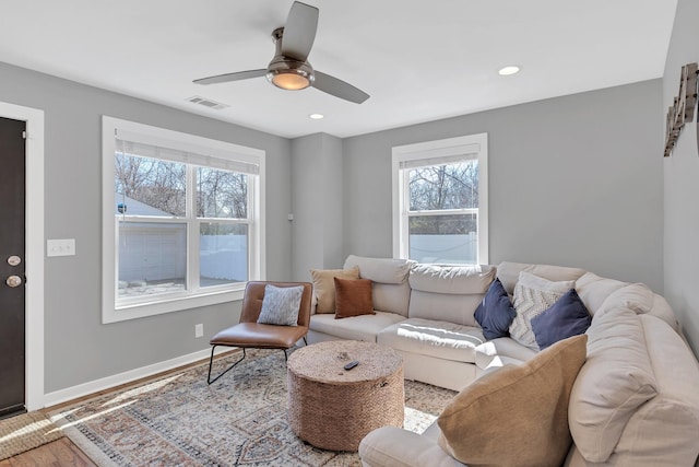 living area featuring wood finished floors, baseboards, visible vents, recessed lighting, and ceiling fan