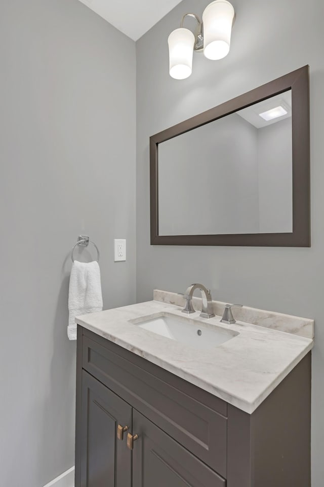 bathroom featuring vanity and baseboards