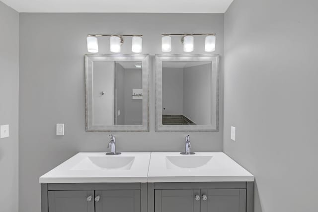 full bathroom with a sink and double vanity