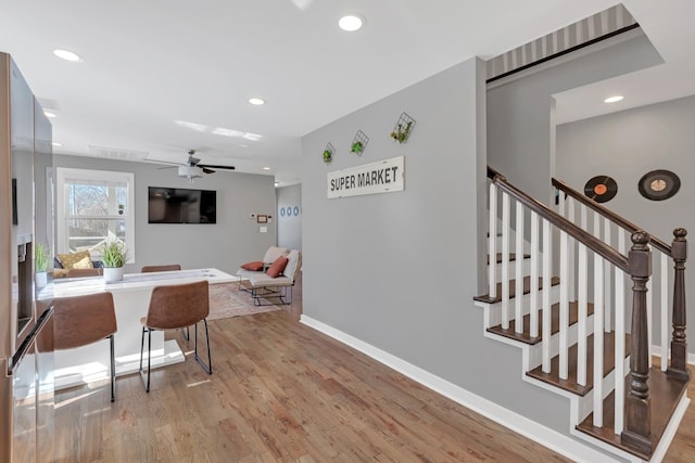 dining area with stairway, recessed lighting, light wood-type flooring, and baseboards