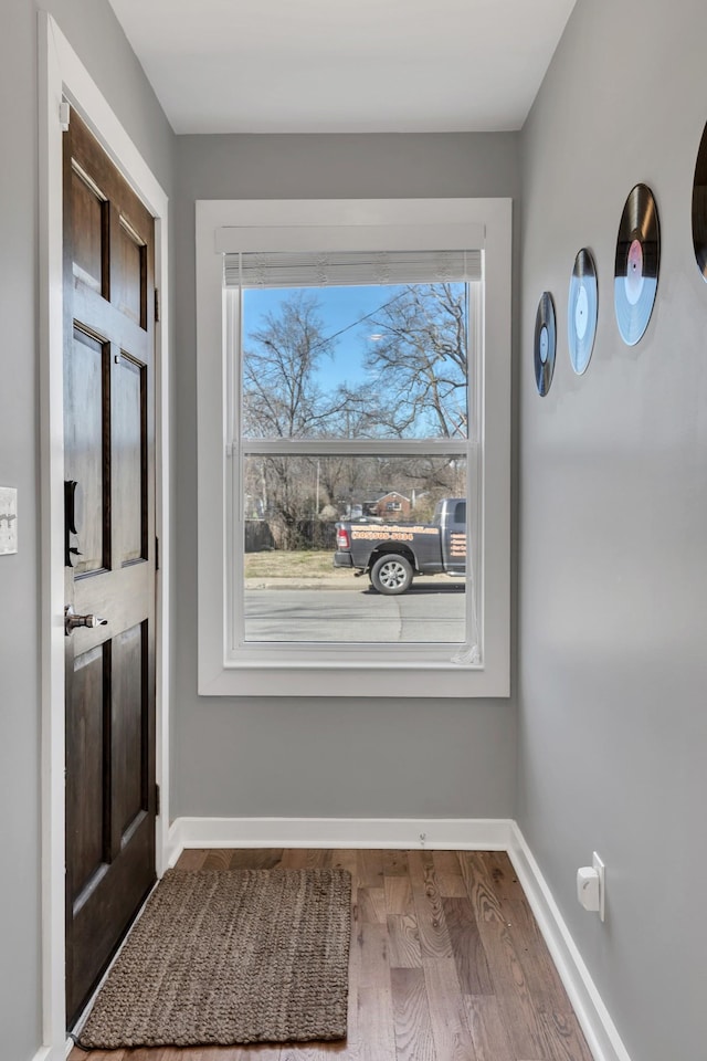 interior space with baseboards and wood finished floors