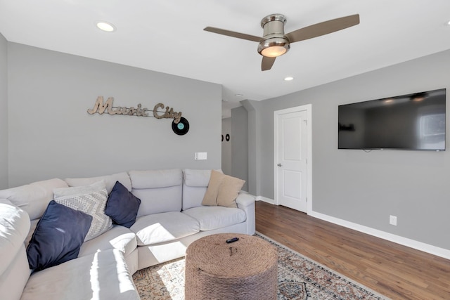 living room featuring a ceiling fan, recessed lighting, wood finished floors, and baseboards