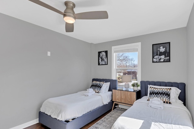 bedroom featuring wood finished floors, baseboards, and ceiling fan