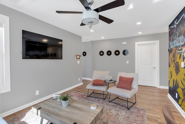 living area with a ceiling fan, recessed lighting, wood finished floors, and baseboards