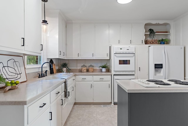 kitchen featuring pendant lighting, open shelves, white cabinetry, white appliances, and light countertops