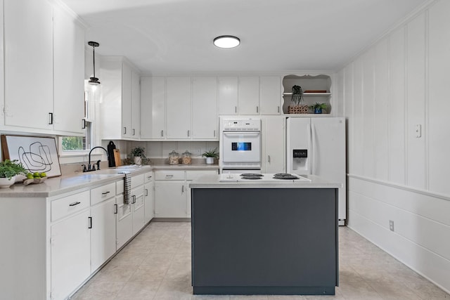 kitchen with open shelves, white appliances, white cabinetry, and light countertops