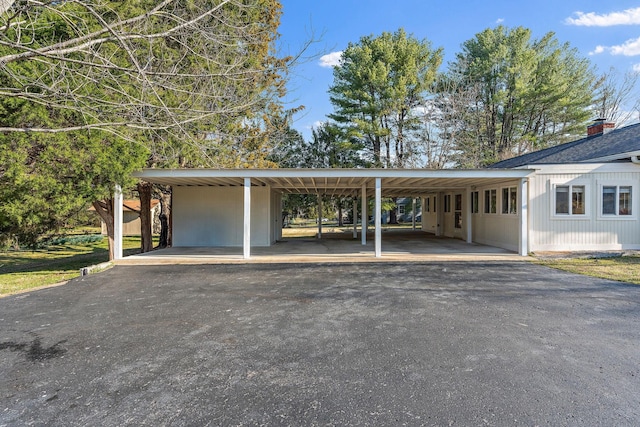 view of parking with a carport and driveway