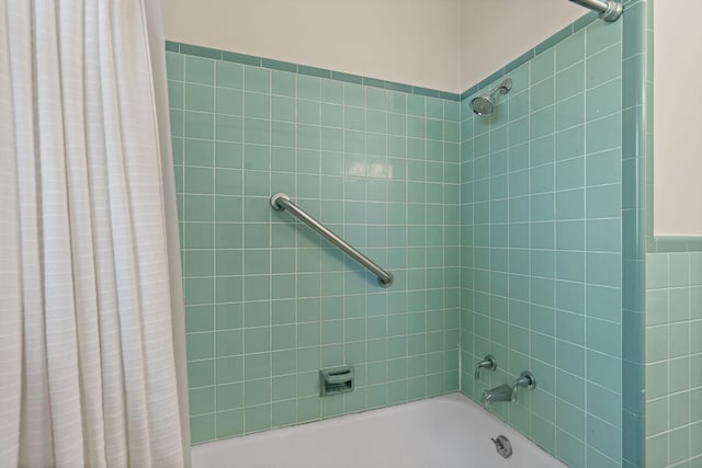 bathroom with shower / bath combo with shower curtain