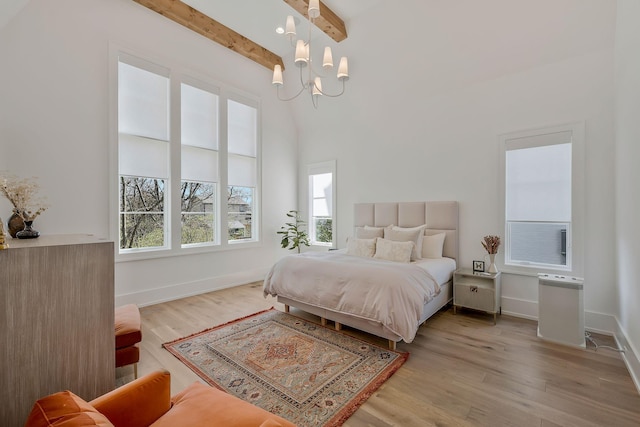 bedroom with beam ceiling, a notable chandelier, baseboards, and wood finished floors