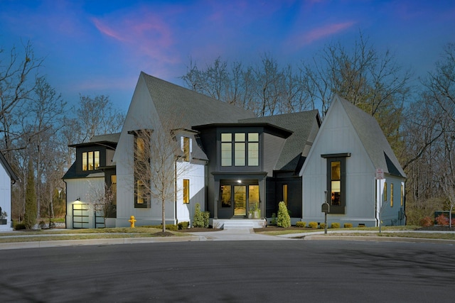 view of front of house featuring board and batten siding and a shingled roof