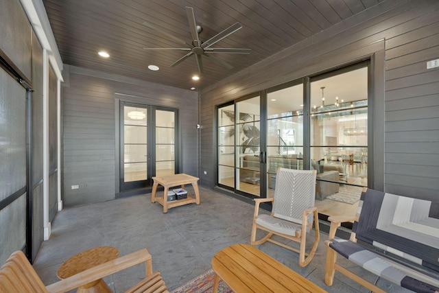 sunroom featuring a ceiling fan, wooden ceiling, and french doors