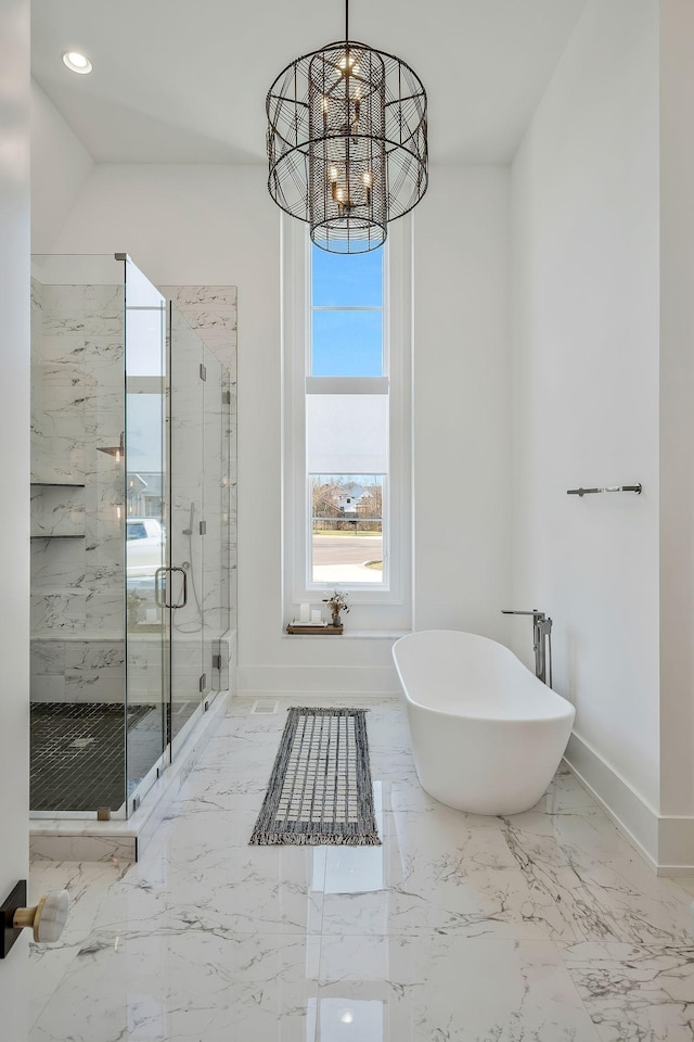 full bathroom with a marble finish shower, baseboards, a notable chandelier, a soaking tub, and marble finish floor