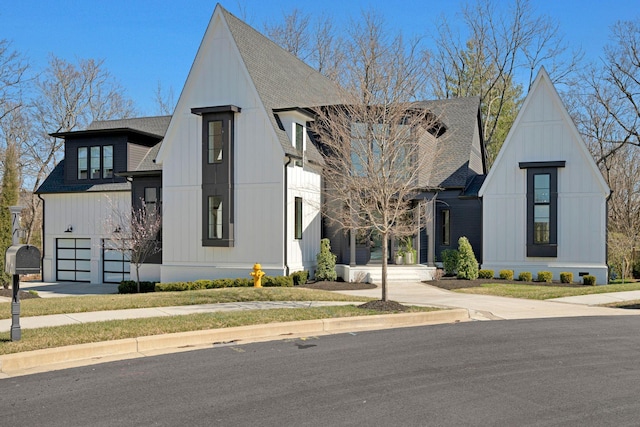 modern farmhouse featuring concrete driveway, board and batten siding, and a shingled roof