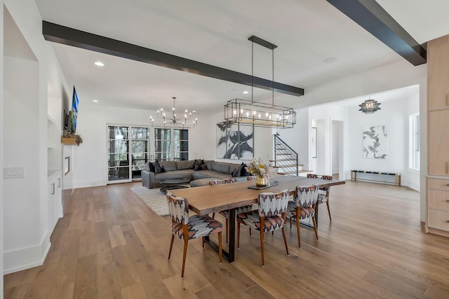 dining space with wood finished floors, a baseboard radiator, an inviting chandelier, beam ceiling, and stairs