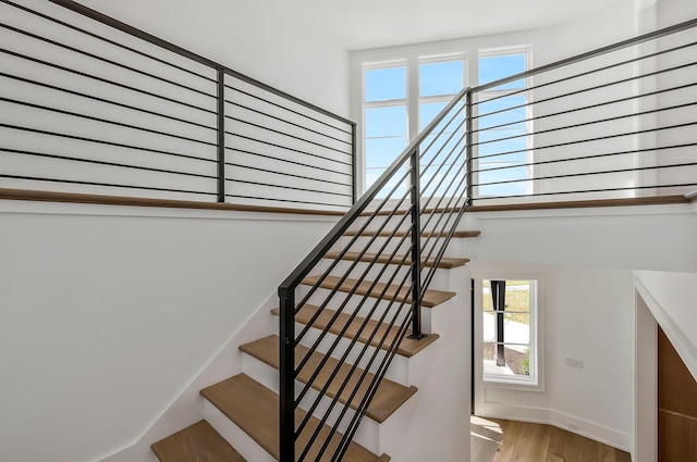 stairs with baseboards and wood finished floors