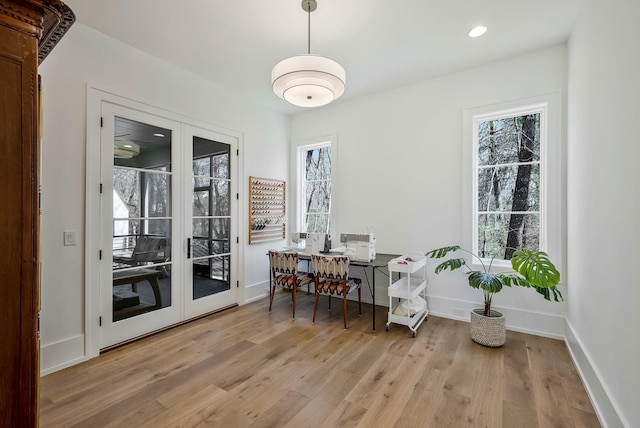 dining room with recessed lighting, french doors, baseboards, and light wood finished floors