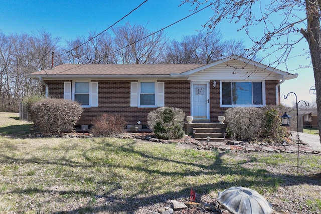 ranch-style home with brick siding and a front lawn